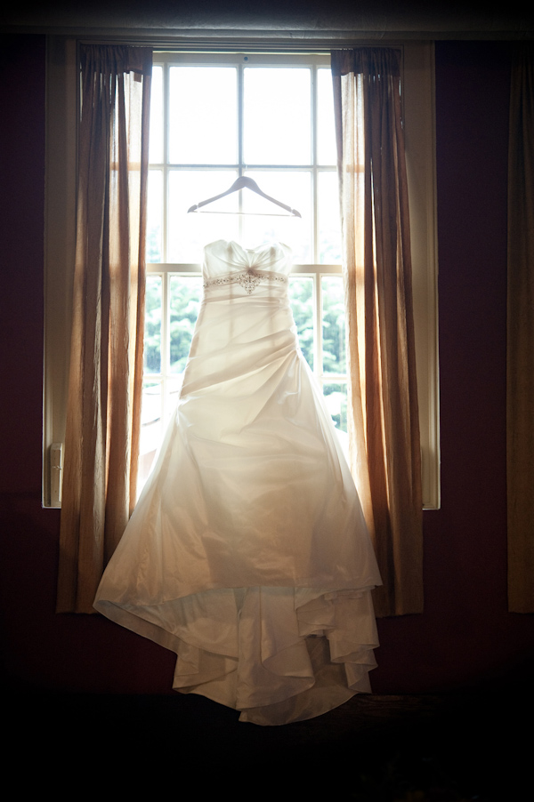 wedding dress hanging in a window, photo by Portland wedding photographer Barbie Hull 